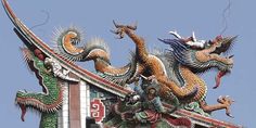 the roof of a building with dragon decorations on it