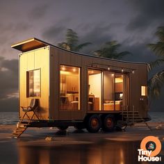 a tiny house on wheels parked in front of the ocean at night with palm trees