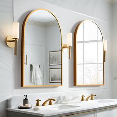 a bathroom with two mirrors and double sinks