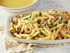 pasta with chicken and parsley in a white dish