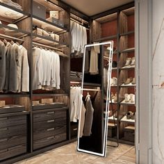 a walk in closet filled with lots of clothes and shoes next to a large mirror