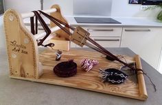 an old fashioned spinning wheel on a cutting board with some candy in it's holder