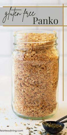 a jar filled with granola next to a spoon