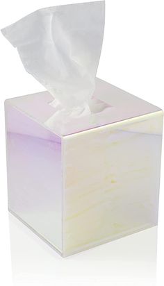 a tissue dispenser sitting on top of a white box