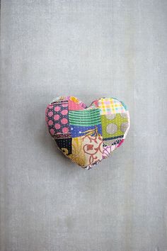 a patchwork heart hanging on the wall