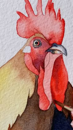 a drawing of a rooster with a red head and yellow crest, holding a pencil in it's left hand