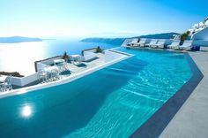 an empty swimming pool next to the ocean