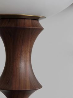 a close up of a wooden table lamp