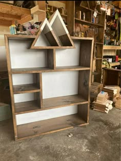 a book shelf made out of wood and some white paint on the inside of it