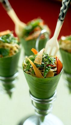 four small cups filled with food on top of a table