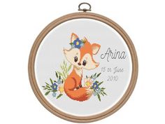 a cross stitch fox with flowers on it's head and the name aria is shown in