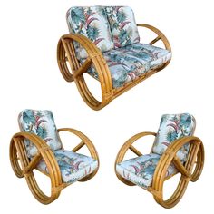 a set of three bamboo chairs with tropical print upholstered seats and back cushions