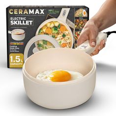 a person is using an electric skillet to cook food in a bowl with eggs