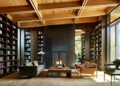 a living room filled with furniture and a fire place next to a bookshelf