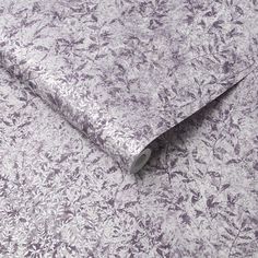 a close up view of a purple and white wallpaper with small flowers on it