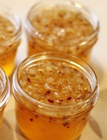 four jars filled with food sitting on top of a table