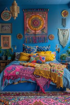 a bedroom with bright blue walls and colorful rugs on the floor, large tapestry hanging above bed