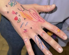 a person's hand with many different designs on it and the word love written in cursive writing