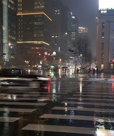 a city street at night in the rain