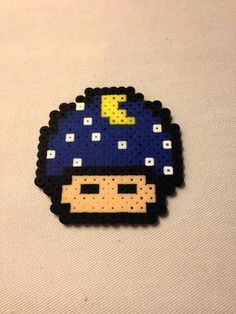 a pixellated image of a person wearing a blue hat with yellow dots on it