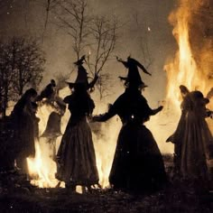 witches dancing around a fire in the woods