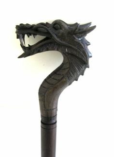 a wooden cane with a dragon head on it