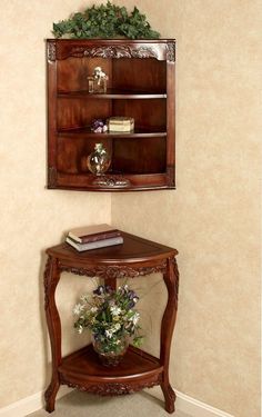 a corner shelf with flowers and books on it next to a wall mounted bookcase