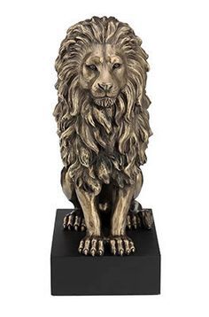 a statue of a lion on a black base