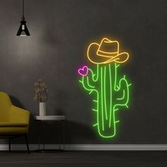 a neon cactus wall decal with a cowboy hat on it's head in a room