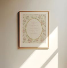 a white wall with a framed quote on it