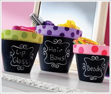 three buckets with writing on them are sitting on a window sill in front of a mirror