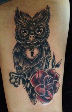 an owl with a key and rose tattoo on the thigh