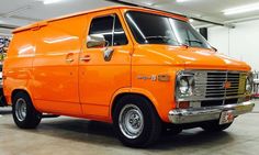 an orange van is parked in a garage