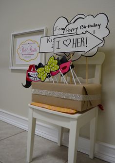 a birthday cake sitting on top of a wooden chair next to a sign that says happy birthday