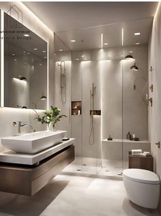 a bathroom with a toilet, sink and shower in it's center wall is illuminated by recessed lighting