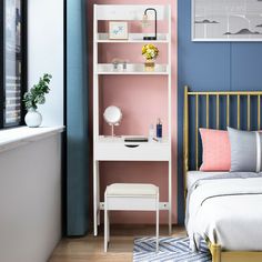 a bedroom with blue walls, pink and white furniture