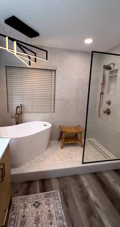 a bathroom with a large bathtub and wooden stool