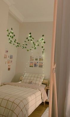 a bed room with a neatly made bed and lights hanging from the ceiling above it