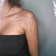 a woman with a tattoo on her shoulder