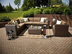 an outdoor living room with brown furniture