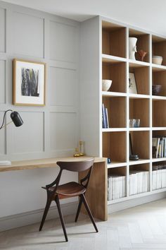 a chair and desk in front of a bookshelf