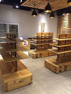 wooden tables and benches are arranged in a room