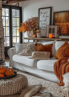 a living room filled with white furniture and lots of oranges on top of it