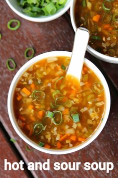 three bowls filled with soup sitting on top of a wooden table