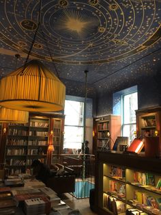 a room with bookshelves and ceiling lights