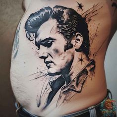 a man's stomach with a tattoo of elvis presley on it and stars in the background