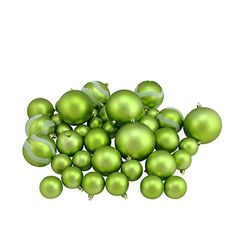 a pile of green christmas ornaments on a white background