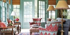 a living room filled with furniture and green doors