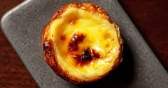 a pastry with cheese on it sitting on a plate