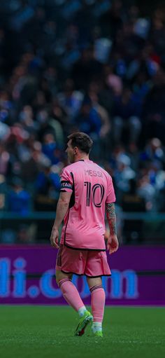 a soccer player is standing on the field